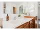 Bathroom vanity with dual sinks, wood cabinets and framed mirror at 9257 Harbor Stream Ave, Las Vegas, NV 89149