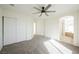 Bright bedroom with neutral carpet, ceiling fan, large closet and bathroom access at 9257 Harbor Stream Ave, Las Vegas, NV 89149
