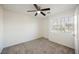 Bedroom with a large window, ceiling fan and plush carpeting at 9257 Harbor Stream Ave, Las Vegas, NV 89149
