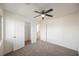 Neutral bedroom with ceiling fan, carpeted floor, closet, and white walls for a serene living space at 9257 Harbor Stream Ave, Las Vegas, NV 89149
