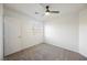 A neutrally painted bedroom features a window with a door and plush carpet at 9257 Harbor Stream Ave, Las Vegas, NV 89149