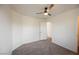 The neutrally painted bedroom has carpet and an open door to the hallway at 9257 Harbor Stream Ave, Las Vegas, NV 89149