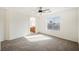 Bright bedroom with neutral carpet, ceiling fan, and arched entryway at 9257 Harbor Stream Ave, Las Vegas, NV 89149