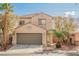 Charming two-story home features a well-maintained front yard and attached two-car garage at 9257 Harbor Stream Ave, Las Vegas, NV 89149