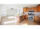Open concept kitchen with stainless steel appliances and adjacent living area at 9257 Harbor Stream Ave, Las Vegas, NV 89149