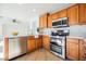 Close up of a kitchen with quartz countertops and stainless steel appliances at 9257 Harbor Stream Ave, Las Vegas, NV 89149