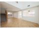 Spacious living room with tile floors, staircase, and natural light from multiple windows at 9257 Harbor Stream Ave, Las Vegas, NV 89149