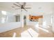 Large living space featuring a kitchen, staircase, and decorative cut-out in the wall at 9257 Harbor Stream Ave, Las Vegas, NV 89149