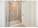 Tiled walk-in shower with glass door and updated fixtures at 9257 Harbor Stream Ave, Las Vegas, NV 89149