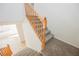 Carpeted staircase with wood railing leads to the upper level of the home at 9257 Harbor Stream Ave, Las Vegas, NV 89149