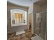 Bathroom featuring a soaking tub, walk-in shower, and a separate toilet room at 1009 Rustridge Ave, North Las Vegas, NV 89081