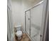 Neat bathroom featuring a toilet and enclosed glass shower that is perfect for guests at 1009 Rustridge Ave, North Las Vegas, NV 89081