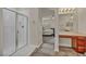 Modern bathroom featuring a glass-enclosed shower, vanity area, and tiled flooring at 1009 Rustridge Ave, North Las Vegas, NV 89081