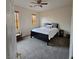 Bright bedroom with a ceiling fan, windows, and plush carpet at 1009 Rustridge Ave, North Las Vegas, NV 89081