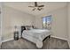 Cozy bedroom with a window, ceiling fan, and plush carpeting at 1009 Rustridge Ave, North Las Vegas, NV 89081