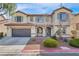 Charming two-story home with a well-manicured front yard and attached two car garage at 1009 Rustridge Ave, North Las Vegas, NV 89081