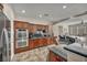 Spacious kitchen featuring stainless steel appliances, wood cabinetry, and granite countertops at 1009 Rustridge Ave, North Las Vegas, NV 89081