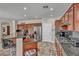 Modern kitchen featuring granite countertops, stainless steel appliances, and island seating at 1009 Rustridge Ave, North Las Vegas, NV 89081