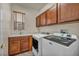 Functional laundry room with ample cabinets, sink, and modern appliances at 1009 Rustridge Ave, North Las Vegas, NV 89081