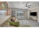 Living room with a ceiling fan, lots of sunlight, and a comfy couch at 1009 Rustridge Ave, North Las Vegas, NV 89081