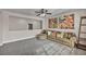Living room with large windows, a comfy couch, and carpet flooring at 1009 Rustridge Ave, North Las Vegas, NV 89081