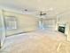 Spacious living room features a fireplace, carpet and lots of natural light from the large windows at 10680 Sapphire Vista Ave, Las Vegas, NV 89144