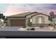 Charming single-story home with stone accents, a two-car garage, and a well-manicured desert landscape at 118 Castanet Ln # Lot 238, Henderson, NV 89011