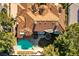 Overhead view of a private backyard with a pristine pool, lush trees, and a large patio at 12 Innisbrook Ave, Las Vegas, NV 89113