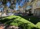 A lush backyard featuring a putting green, pool, fountain, and covered outdoor kitchen area at 12 Innisbrook Ave, Las Vegas, NV 89113