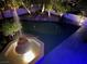 Aerial nighttime view of a water fountain and backyard putting green at 12 Innisbrook Ave, Las Vegas, NV 89113