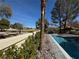 Inviting outdoor scene with a pool, patio, lush greenery, and a view of a nearby golf course at 12 Innisbrook Ave, Las Vegas, NV 89113