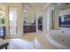 Spacious bathroom featuring a soaking tub, walk-in shower, vanity, and walk-in closet at 12 Innisbrook Ave, Las Vegas, NV 89113