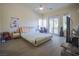 Comfortable bedroom with a guitar, a drumset, a flat-screen TV, and lots of natural light at 12 Innisbrook Ave, Las Vegas, NV 89113