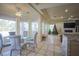 Bright dining area with large windows, a glass-top table, and comfortable chairs at 12 Innisbrook Ave, Las Vegas, NV 89113
