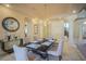 Formal dining room featuring elegant decor, a stylish chandelier, and views into other parts of the home at 12 Innisbrook Ave, Las Vegas, NV 89113