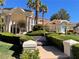 Elegant home showcasing stately columns, lush landscaping, and tiled roof at 12 Innisbrook Ave, Las Vegas, NV 89113