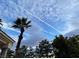 Exterior shot showcasing palm trees against a cloudy sky, adding a touch of tropical paradise to the property at 12 Innisbrook Ave, Las Vegas, NV 89113