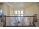 A view from the 2nd story with a decorative railing overlooking the home's living area at 12 Innisbrook Ave, Las Vegas, NV 89113