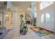 Grand foyer featuring a spiral staircase, tile flooring, and a unique water feature for a luxurious entrance at 12 Innisbrook Ave, Las Vegas, NV 89113
