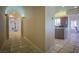 Hallway featuring stone floors and access to the kitchen and decorative archways and pillars at 12 Innisbrook Ave, Las Vegas, NV 89113