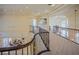 Hallway overlooking the dining room with carpeted floors, ornamental railings, and custom ceilings at 12 Innisbrook Ave, Las Vegas, NV 89113