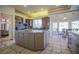Open kitchen with a center island, granite counters, stainless appliances, and an adjacent dining area at 12 Innisbrook Ave, Las Vegas, NV 89113