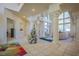 Elegant living space featuring tile flooring, grand columns, and abundant natural light from large windows at 12 Innisbrook Ave, Las Vegas, NV 89113