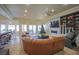 Spacious living room with a large sectional couch, a fireplace, and an entertainment center at 12 Innisbrook Ave, Las Vegas, NV 89113