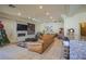Spacious living room with tiled floors, granite bar, fireplace, and a large sectional couch at 12 Innisbrook Ave, Las Vegas, NV 89113