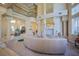 Open-concept living area featuring grand columns, a cozy fireplace, and seamless flow into adjacent spaces at 12 Innisbrook Ave, Las Vegas, NV 89113