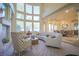 Bright living area boasting high ceilings, expansive windows, and seamlessly connects to the dining area at 12 Innisbrook Ave, Las Vegas, NV 89113