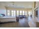 Bright main bedroom featuring light wood floors, a sitting area and access to a balcony at 12 Innisbrook Ave, Las Vegas, NV 89113