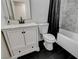 Bathroom features black tile flooring, a white vanity with a marble countertop, and a bathtub with a shower at 1500 Saylor Way, Las Vegas, NV 89108