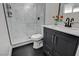 Bathroom features white tiled shower with glass door, updated vanity with marble countertop, and black fixtures at 1500 Saylor Way, Las Vegas, NV 89108